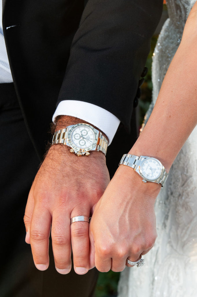 bride and groom showcasing their Rolex watches on their wedding day in downtown Detroit
