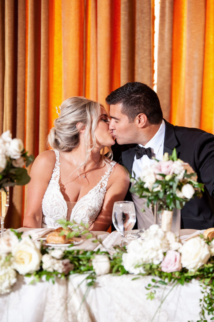 married couple kiss during their wedding reception at the Colony Club in downtown Detroit