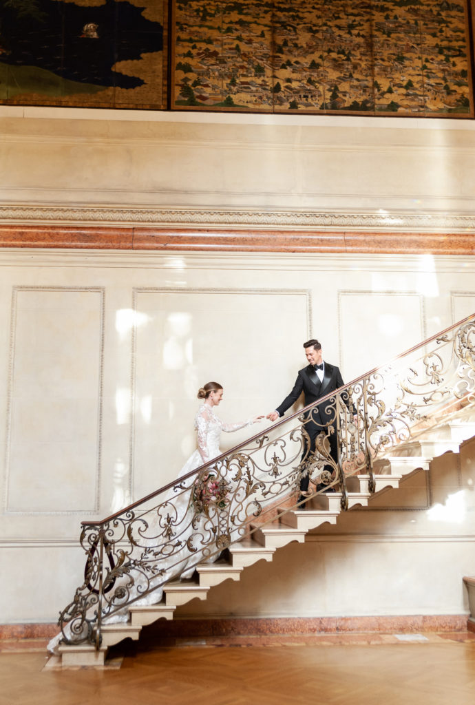bride and groom walking up the stairs at their Anderson House wedding