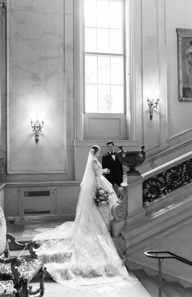 groom guiding his bride up the stairs at their Anderson House wedding 