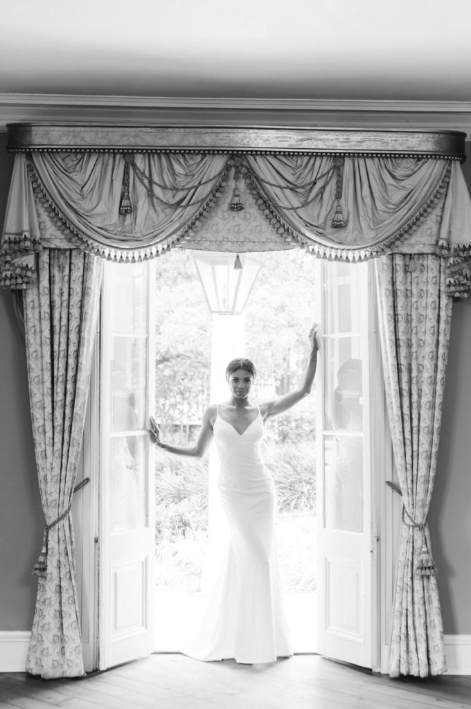 bride standing in a doorway at Charleston's William Aiken House