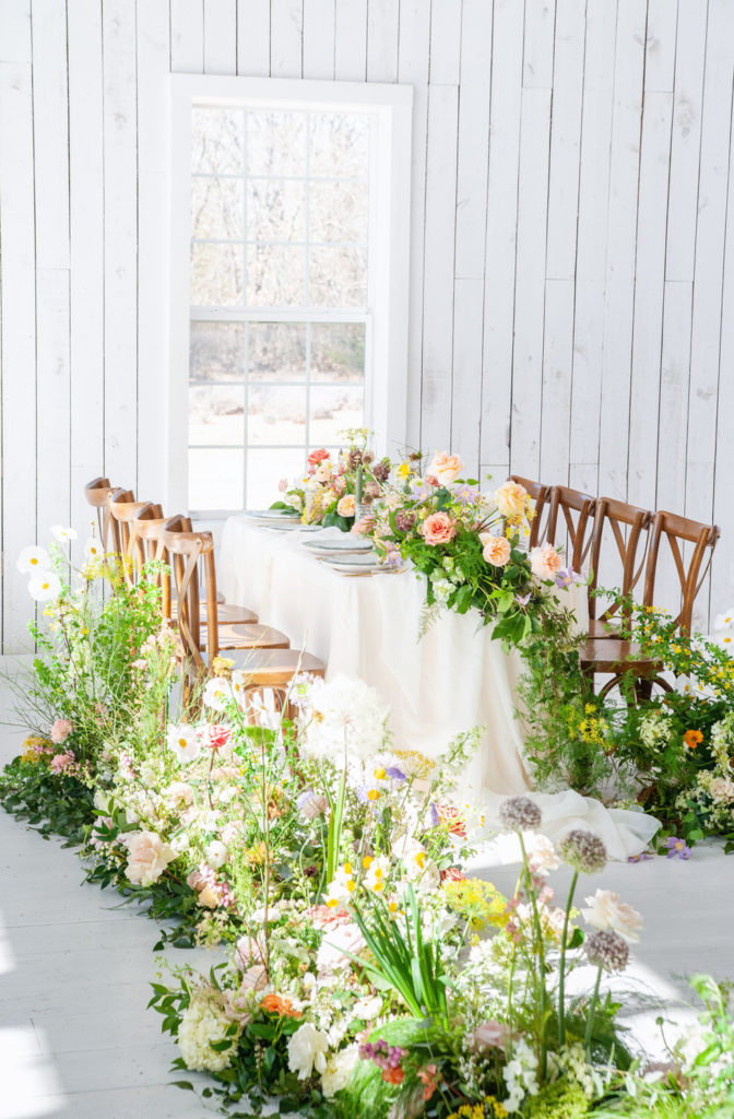 bright spring wedding reception table set up at the White Sparrow Barn
