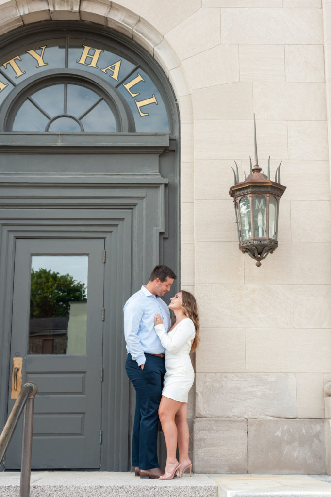 couple hugging outside the city hall building in Manistee Michigan
