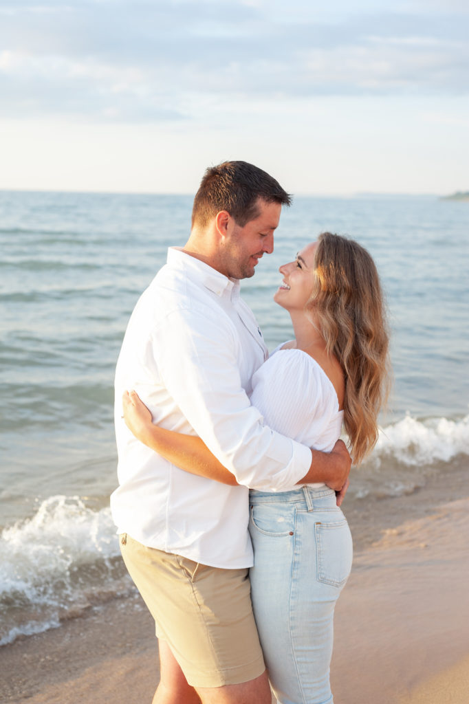 couple smiling and hugging on Lake Michigan
