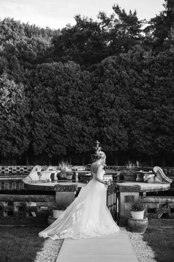 bride walking towards a water fountain