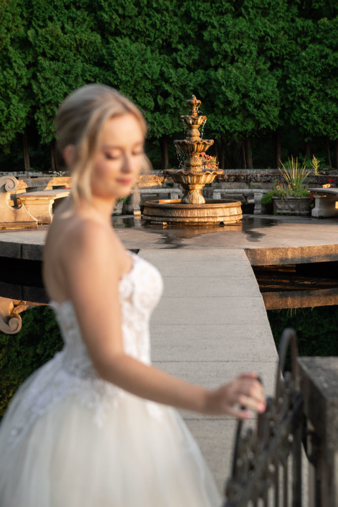 water fountain with bride out of focus in the foreground 