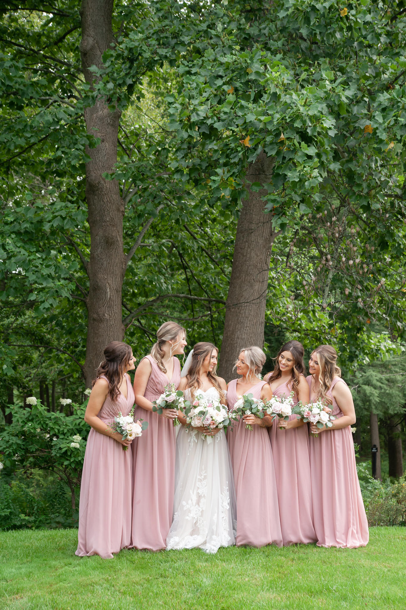 bride and her bridesmaids in pink dresses in saugatuck Michigan