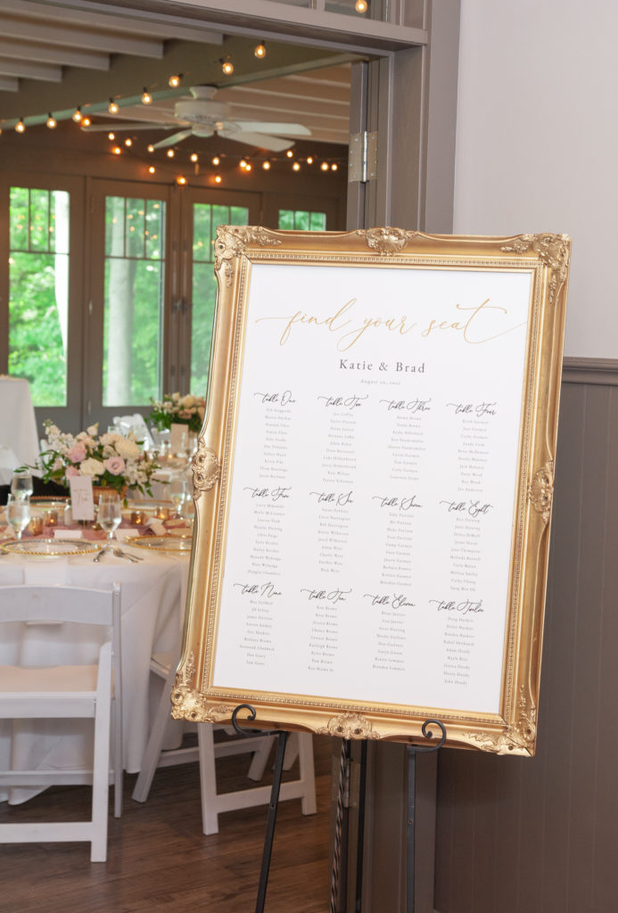 wedding reception seating chart in a gold ornate frame