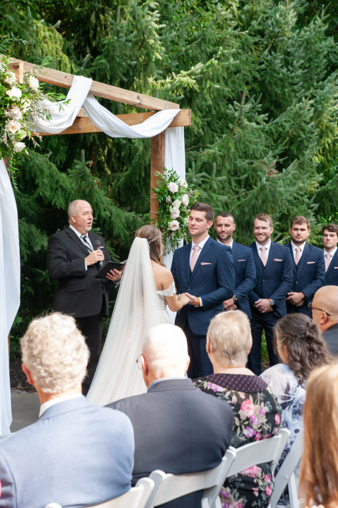 groom saying his vows during the outdoor wedding ceremony 