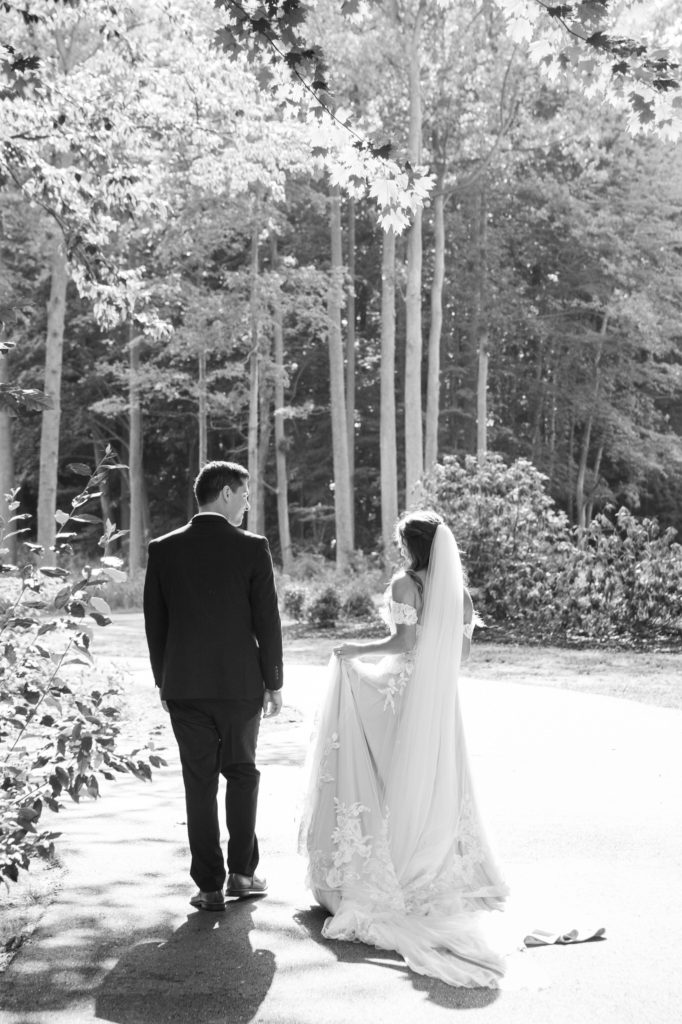 black and white picture of bride and groom on a paved pathway