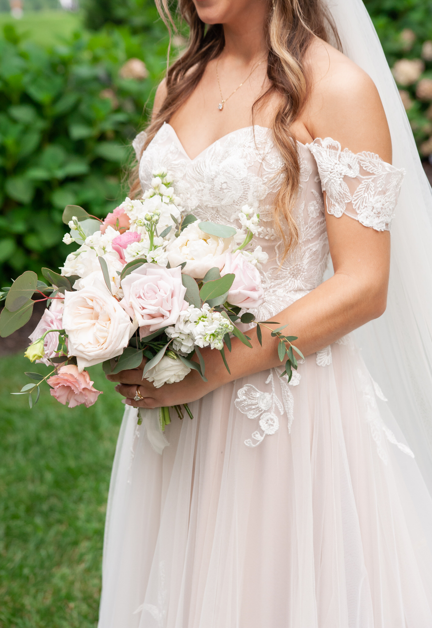 lace strapless wedding dress and pink floral bouquet 