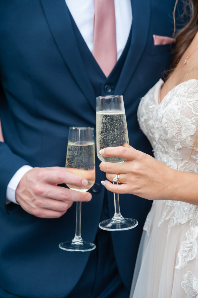 bride and groom holding champagne glasses 
