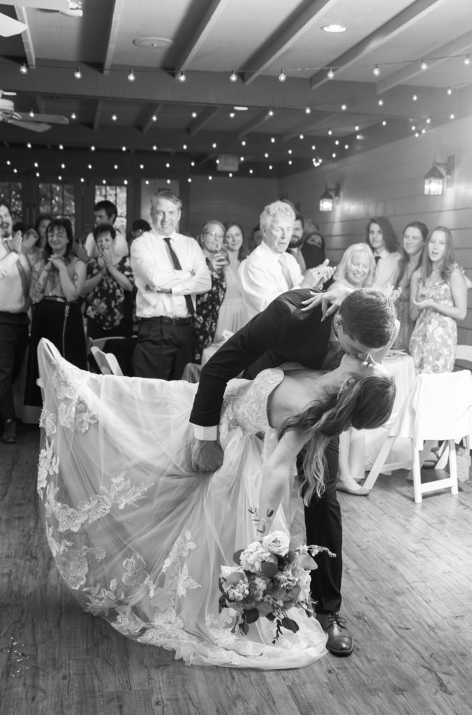 groom dipping and kissing his bride during their grand entrance 