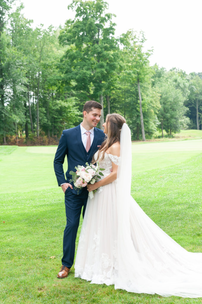 bride and groom smiling at each other at Ravines Golf Club