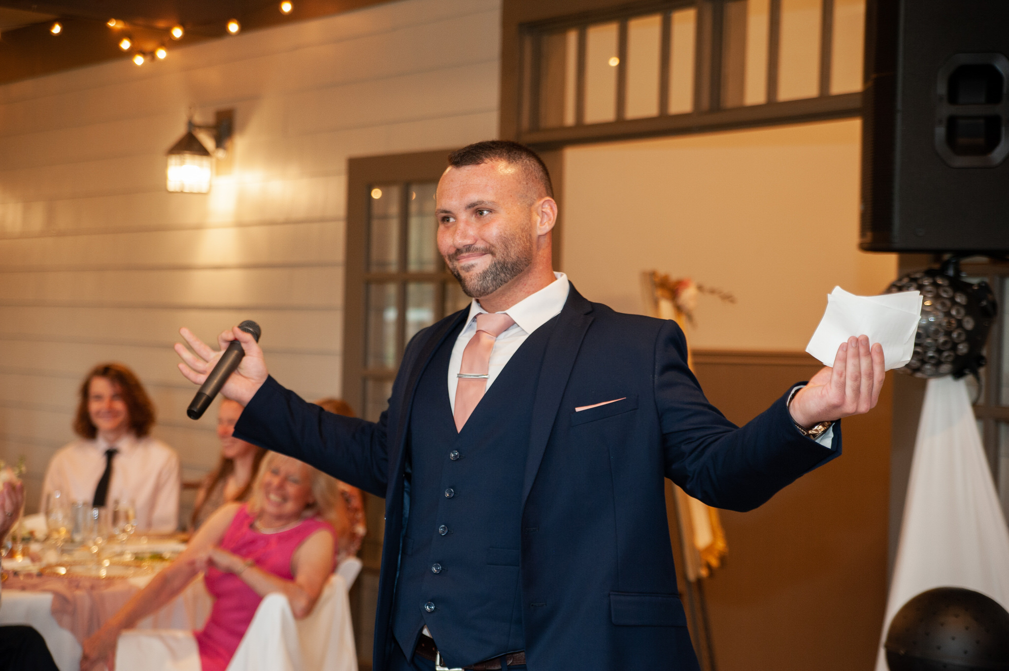 groomsman with his arms open during his speech