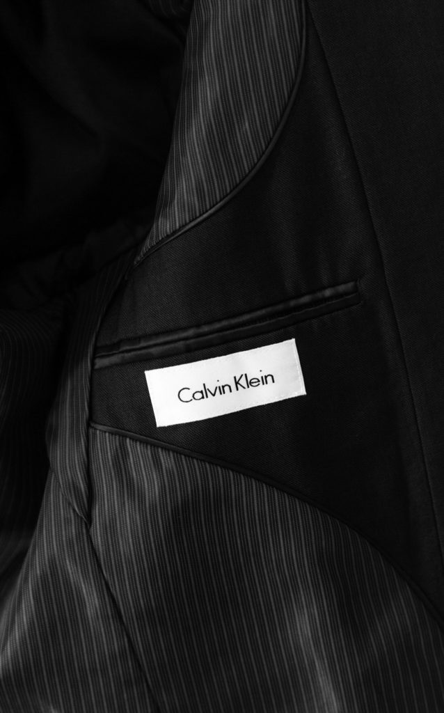 the inside details of a navy calvin klein suit jacket