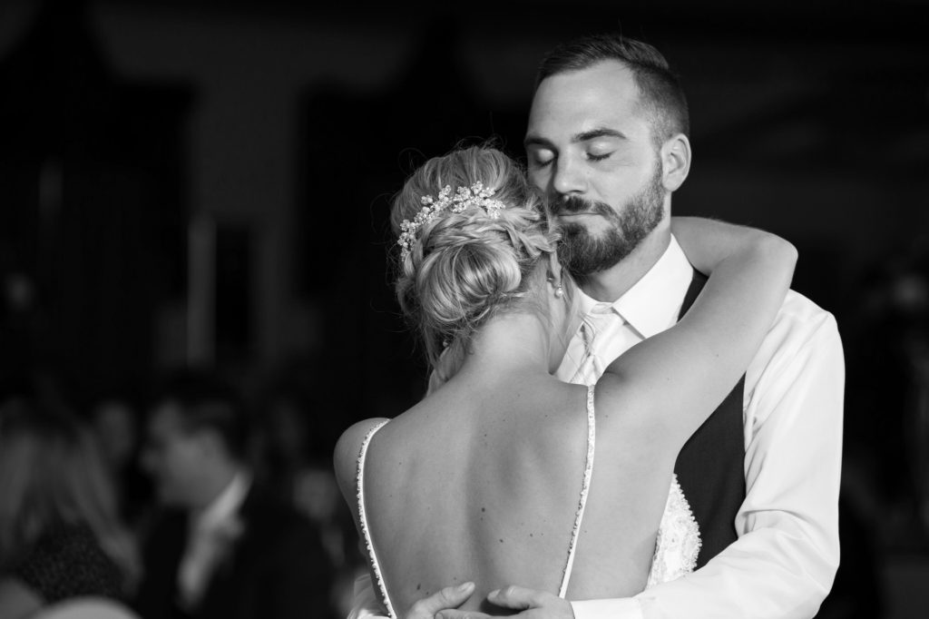 groom holds his bride during their first dance at their Bavarian Inn Lodge wedding reception