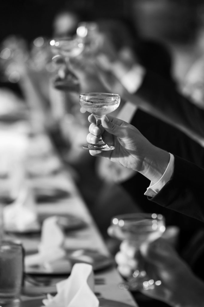 guests raising their champagne glasses during a bavarian inn wedding toast 