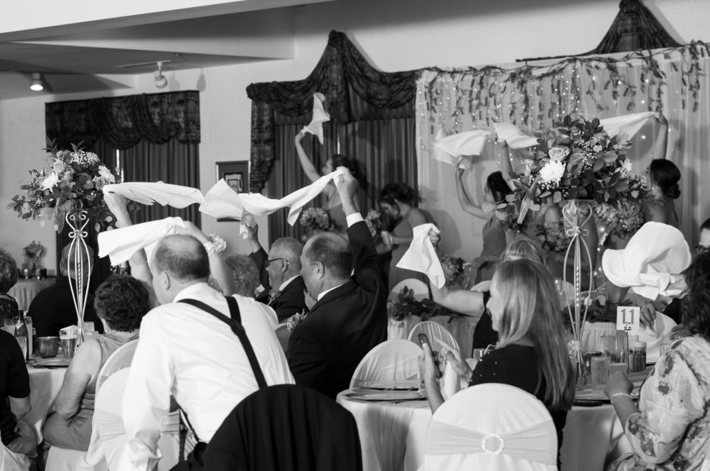 wedding guests wave their white napkins during a summer wedding reception at the Bavarian inn Lodge in Frankenmuth