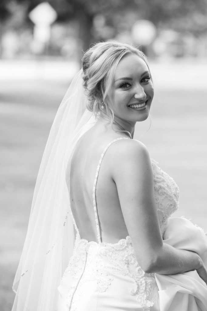 bride smiling back at the camera looking over her shoulder