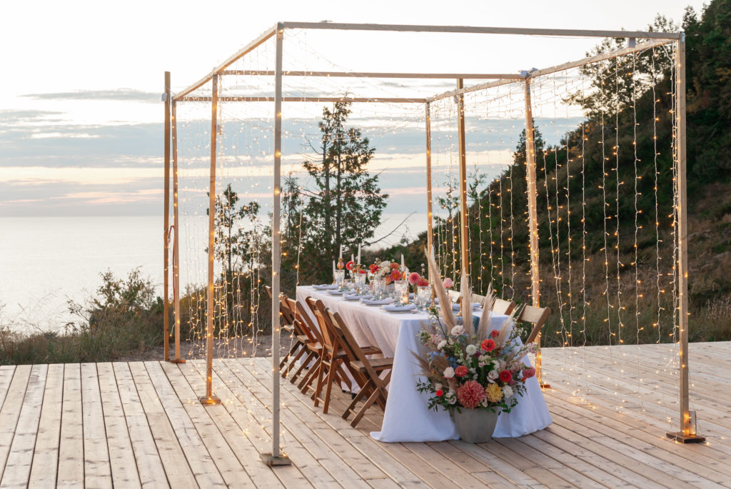 Romantic outdoor wedding reception table at Lake Bluff Preserve in Frankfort, Michigan