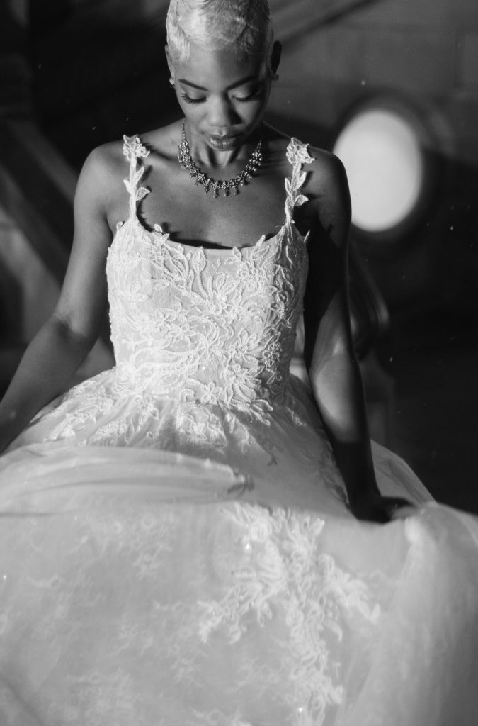 bride wearing a lacey strapped ball gown wedding dress