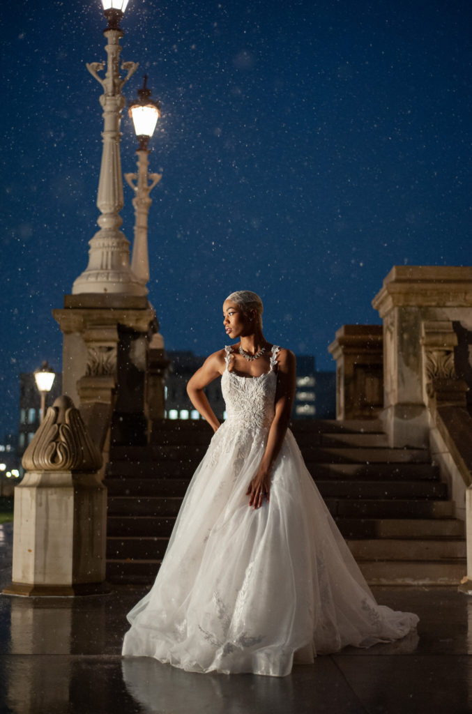 bride looking over her shoulder in the snow at the Michigan capitol building in Lansing