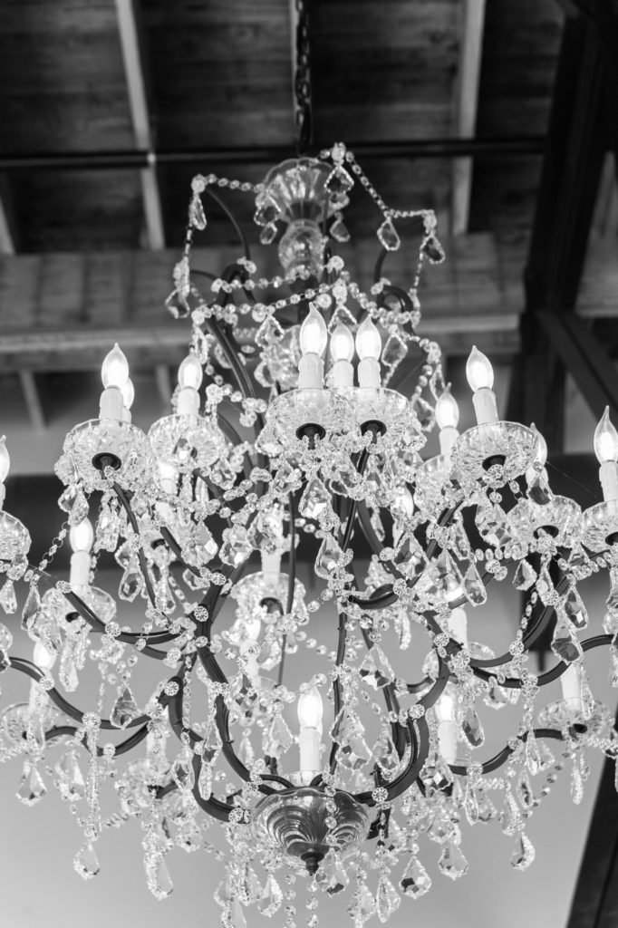 chandelier hanging from the industrial ceiling of the high five wedding venue in downtown grand rapids