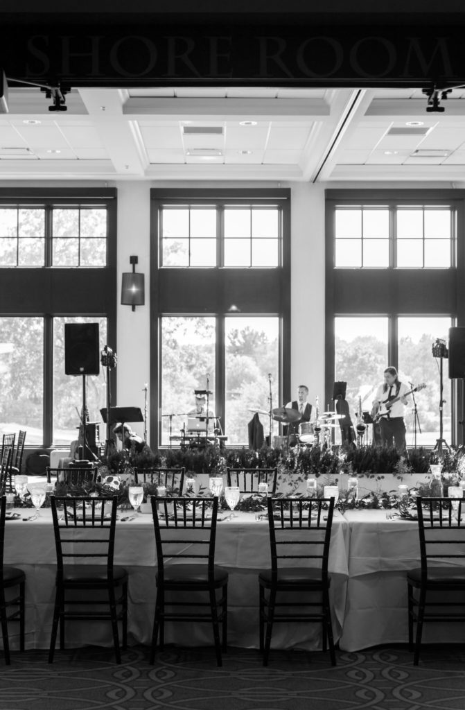 wedding reception table with a band performing in the background at the Watermark Country Club