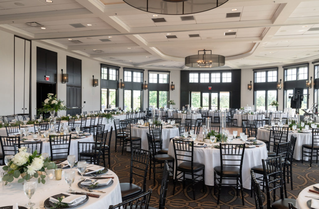 modern black and white wedding reception tables set up in the ballroom of Watermark Country Club