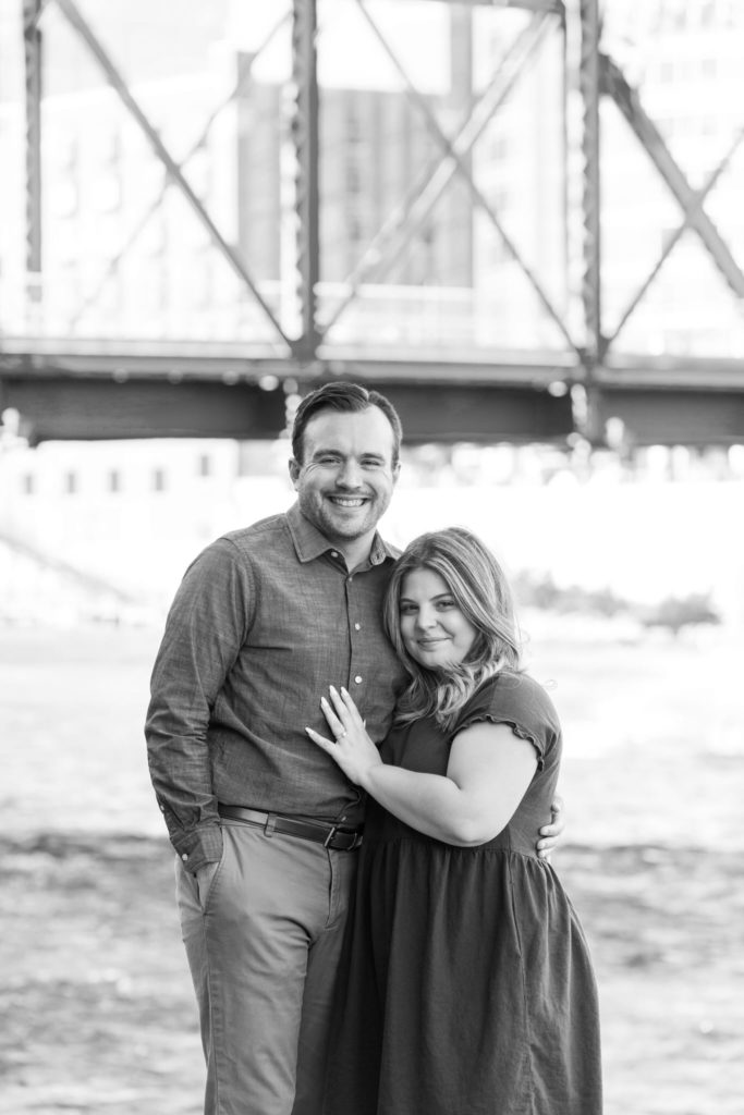 couple smiles at the camera after their downtown Grand Rapids wedding proposal