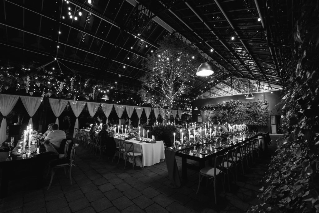 wide angle of a wedding reception at night time inside the Planterra Conservatory greenhouse