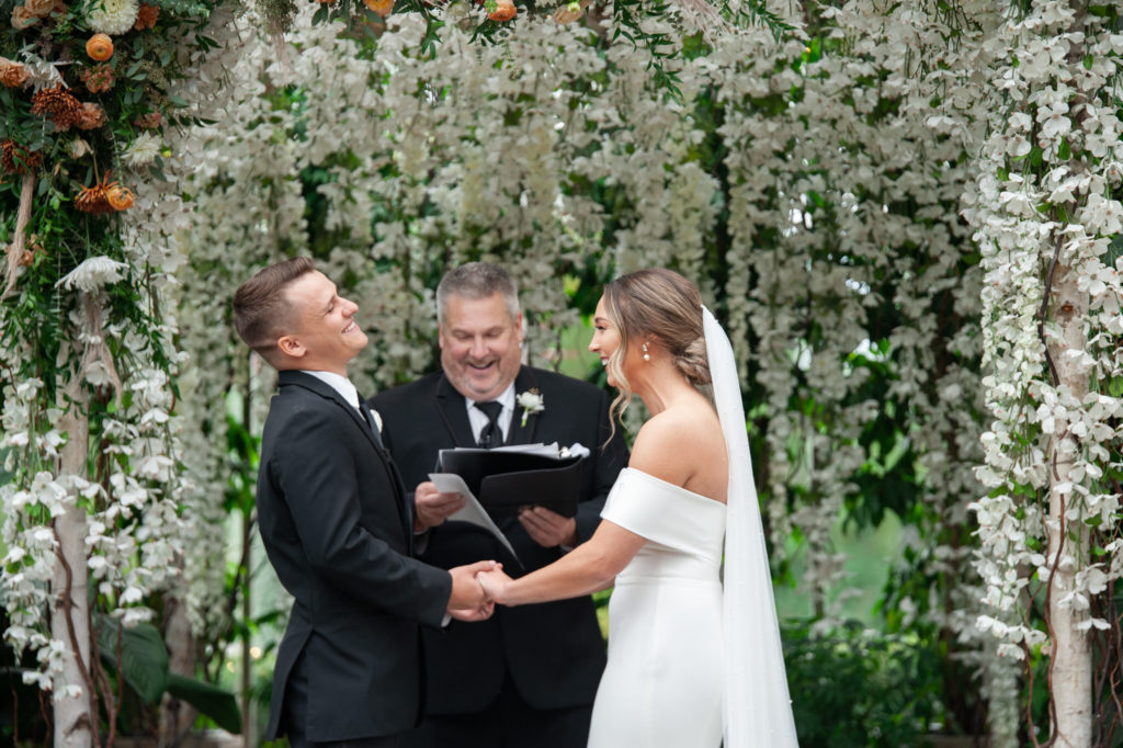 bride and groom smile from ear to ear during their Planterra Conservatory wedding reception in the fall