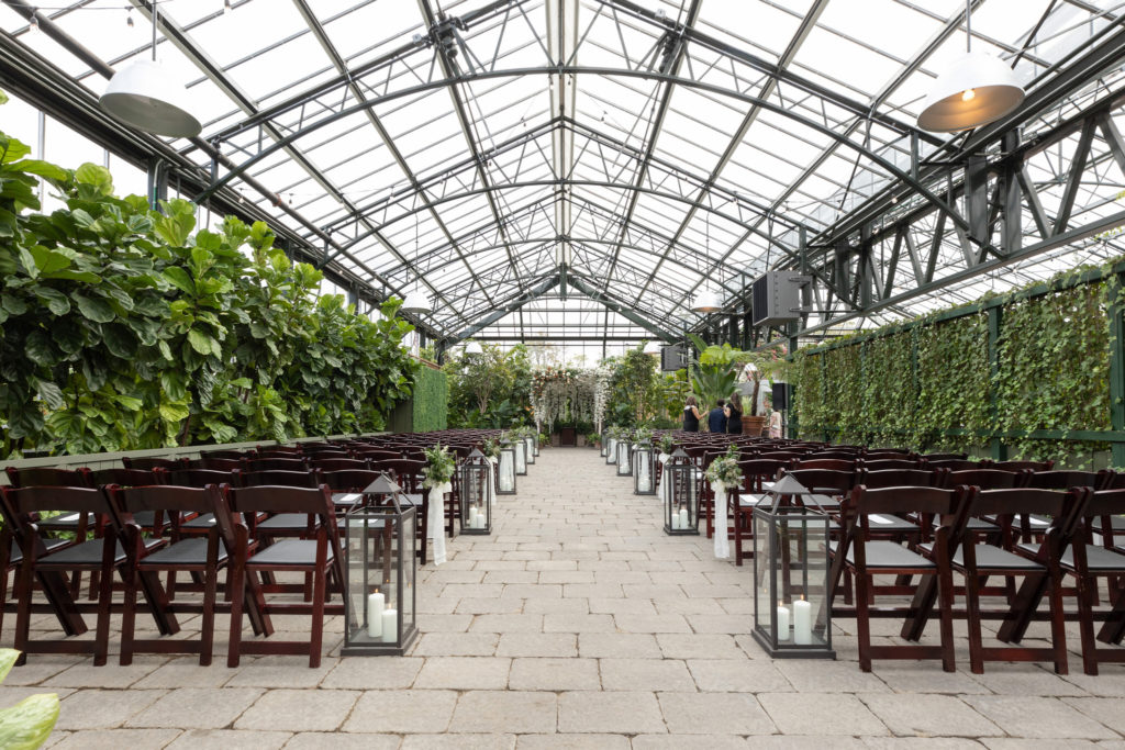 Wide angle view of a botanical wedding ceremony at Planterra Conservatory in West Bloomfield, Michigan