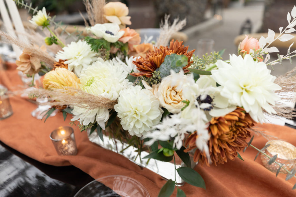fall inspired wedding table centerpiece with orange and white flowers