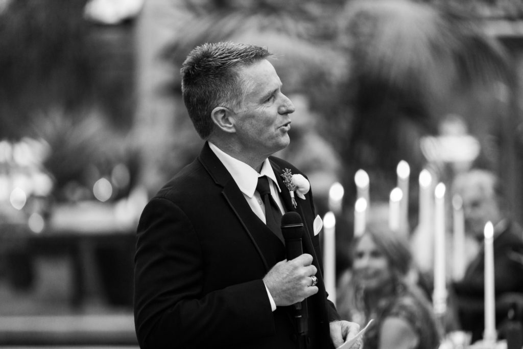 father gives a speech during his daughters wedding reception