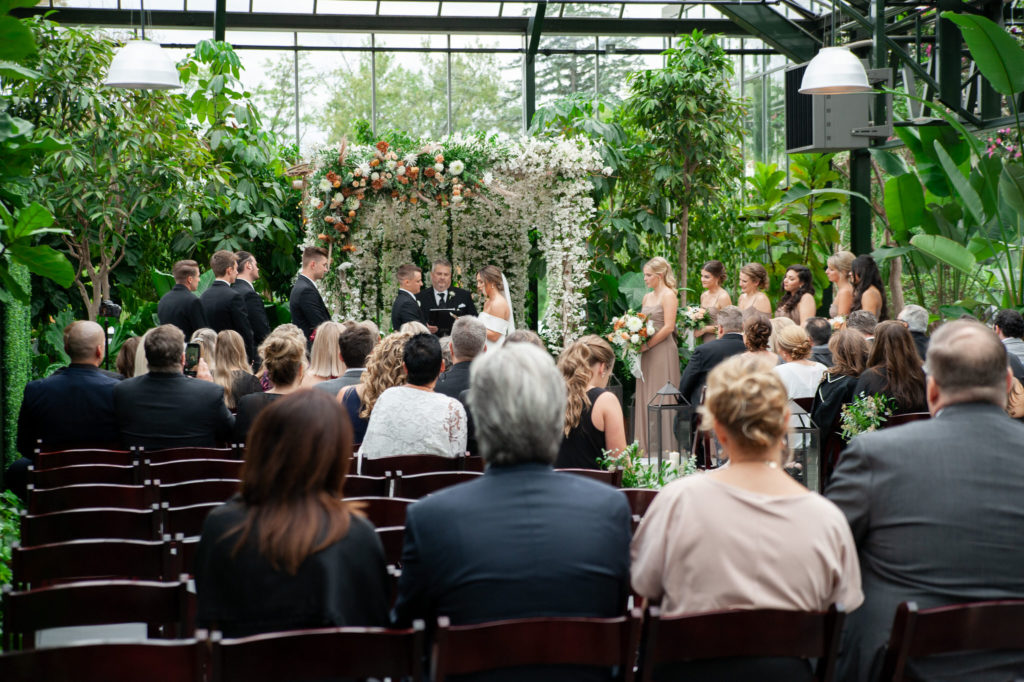 a beautiful lush wedding ceremony inside the Planterra Conservatory