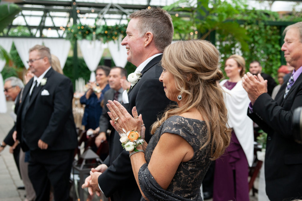 mother of the bride applauds after her daughter is married