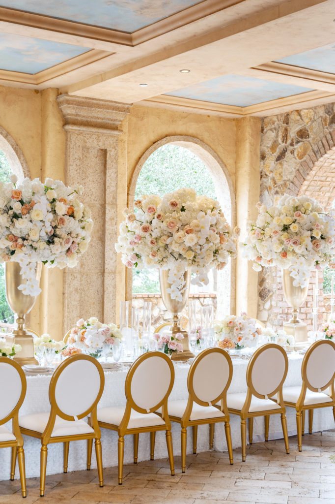 extravagant wedding reception table under the brick arch entryway of Bella Collina in central Florida