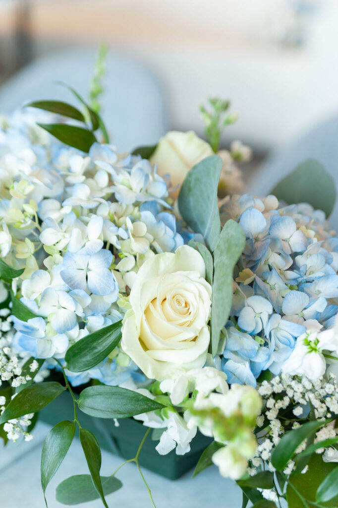 white rose and blue hydrangeas floral centerpiece 