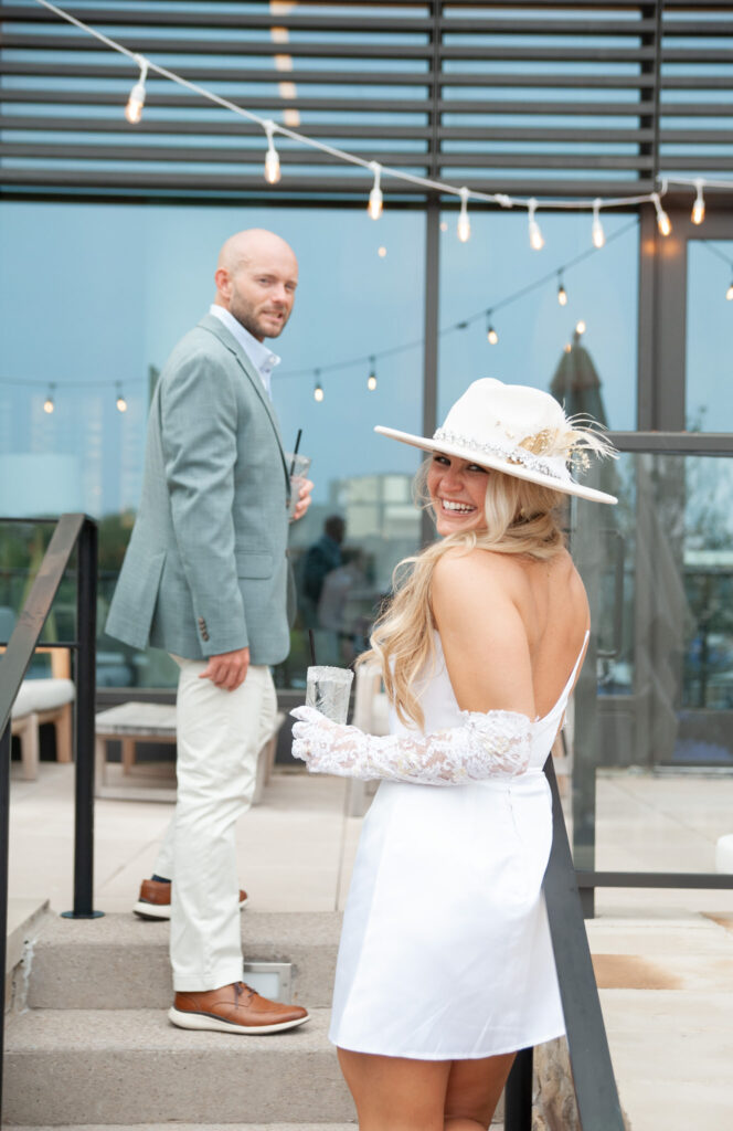 bride and groom smile during their wedding rehearsal dinner outside the modern Drey Hotel