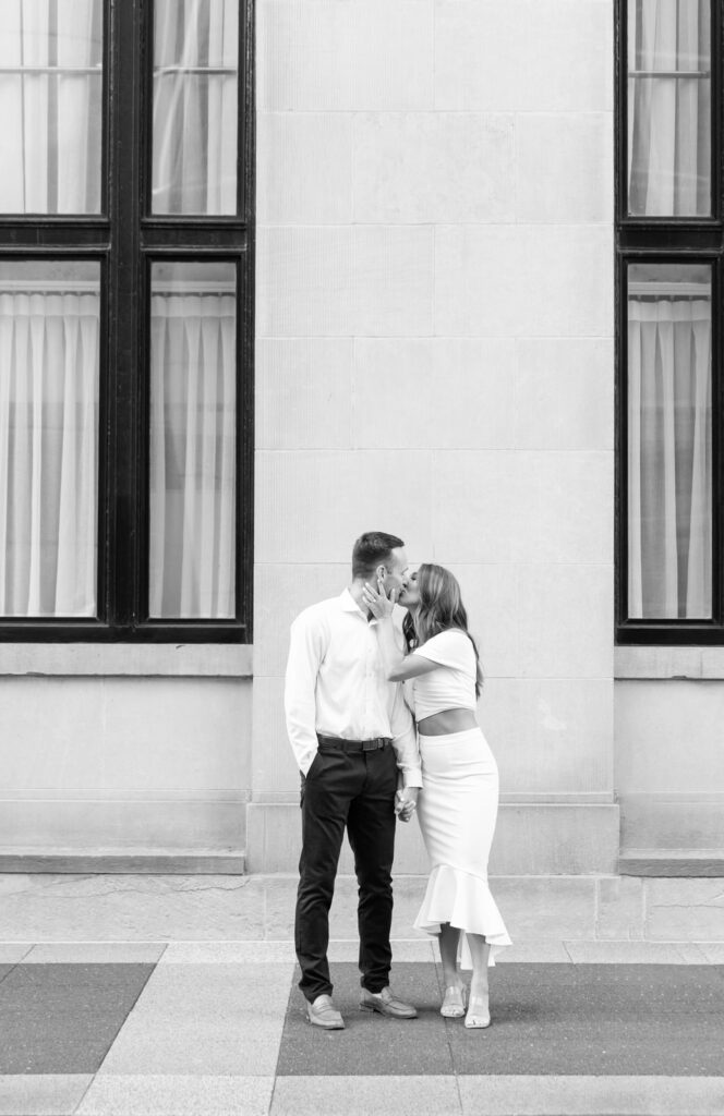 classic couple shares a kiss in front of the Amway Grand Plaza Hotel in Grand Rapids