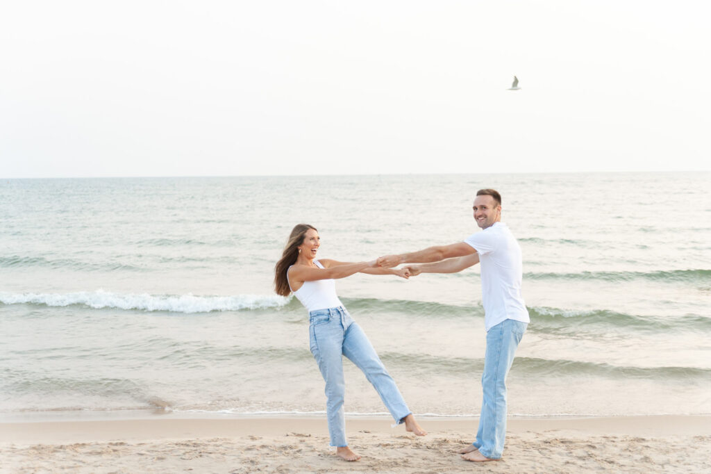 playful couple during their Grand Haven engagement photo session