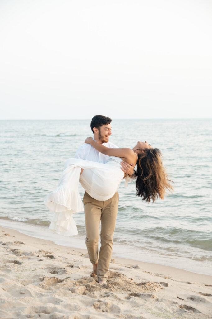 couple being playful and smiling during their Olive Shores engagement photos