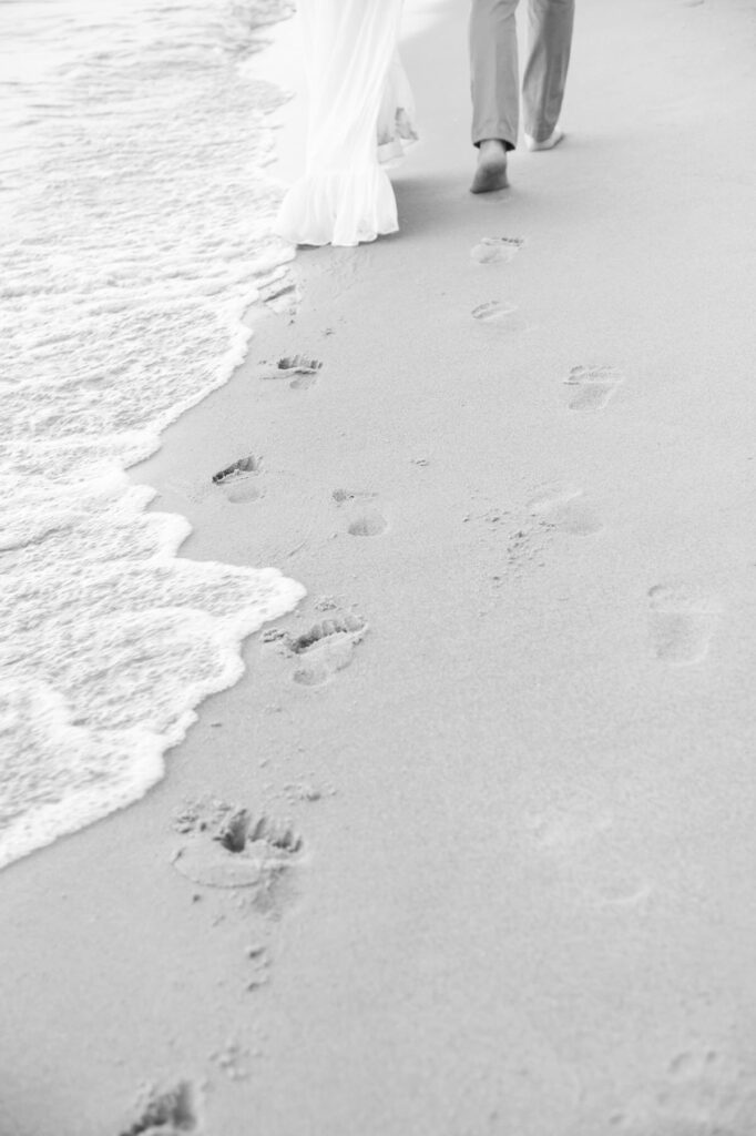 footprints in the sand during an engagement session on the shores of Lake Michigan