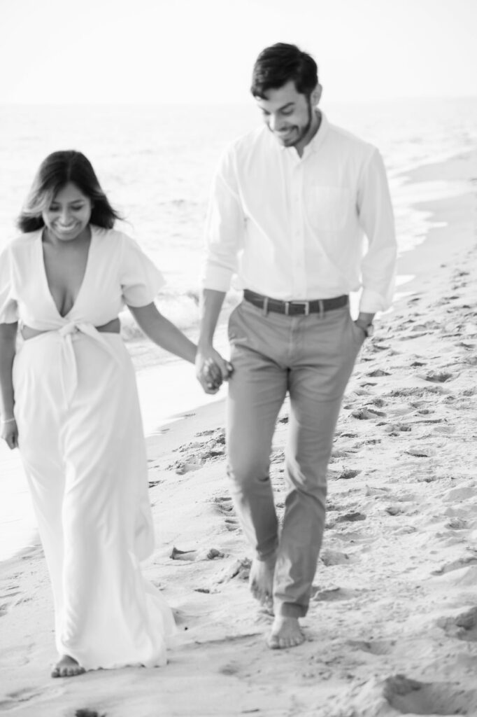 couple walking down the beach holding hands