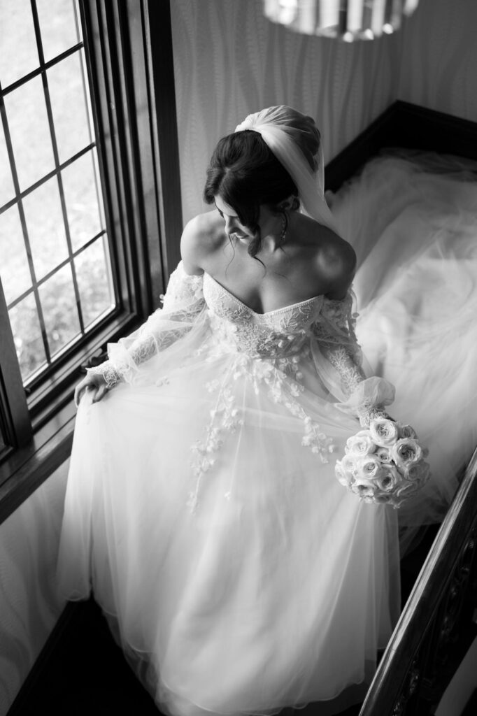 bride walking down the staircase in the Astoria gown by Eva Lendel at her Venue3Two wedding in Grand Rapids