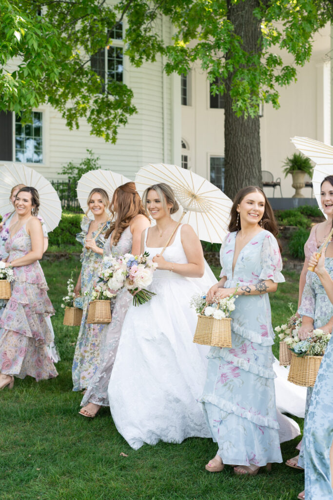 bride walking and smiling with her bridesmaids at her spring Waldenwoods Wedding