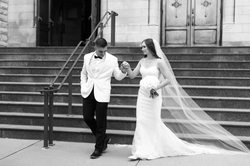 bride and groom walking down the stairs of Basilica of St. Adalbert after their wedding ceremony 