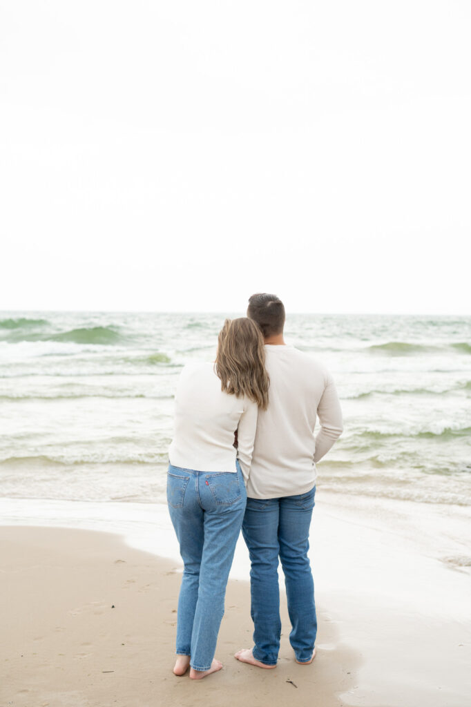 couple watching and enjoying the white cap waves of Lake Michigan